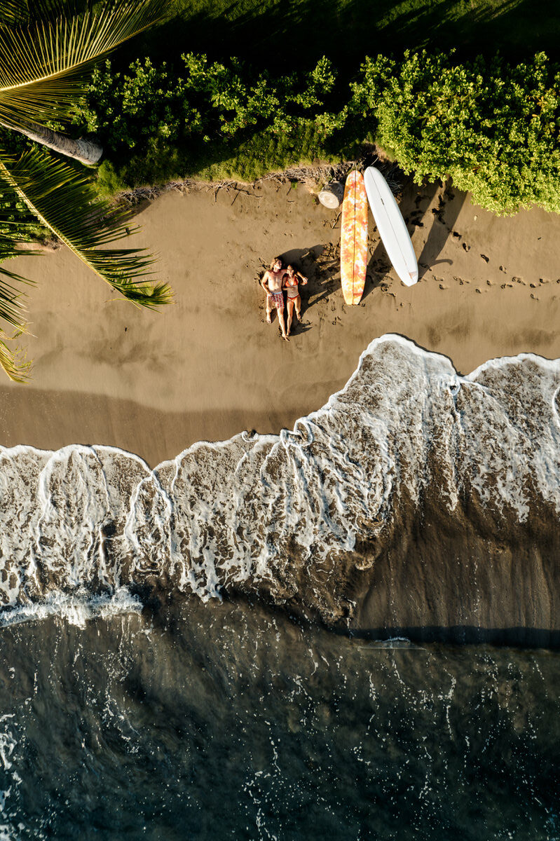 drone photo of surf couple on the beach. Maui, Hawaii