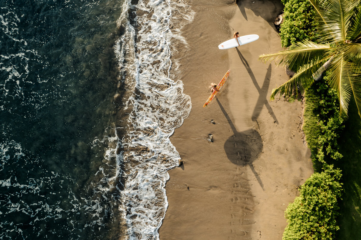 drone photo of surf couple on the beach. Maui, Hawaii